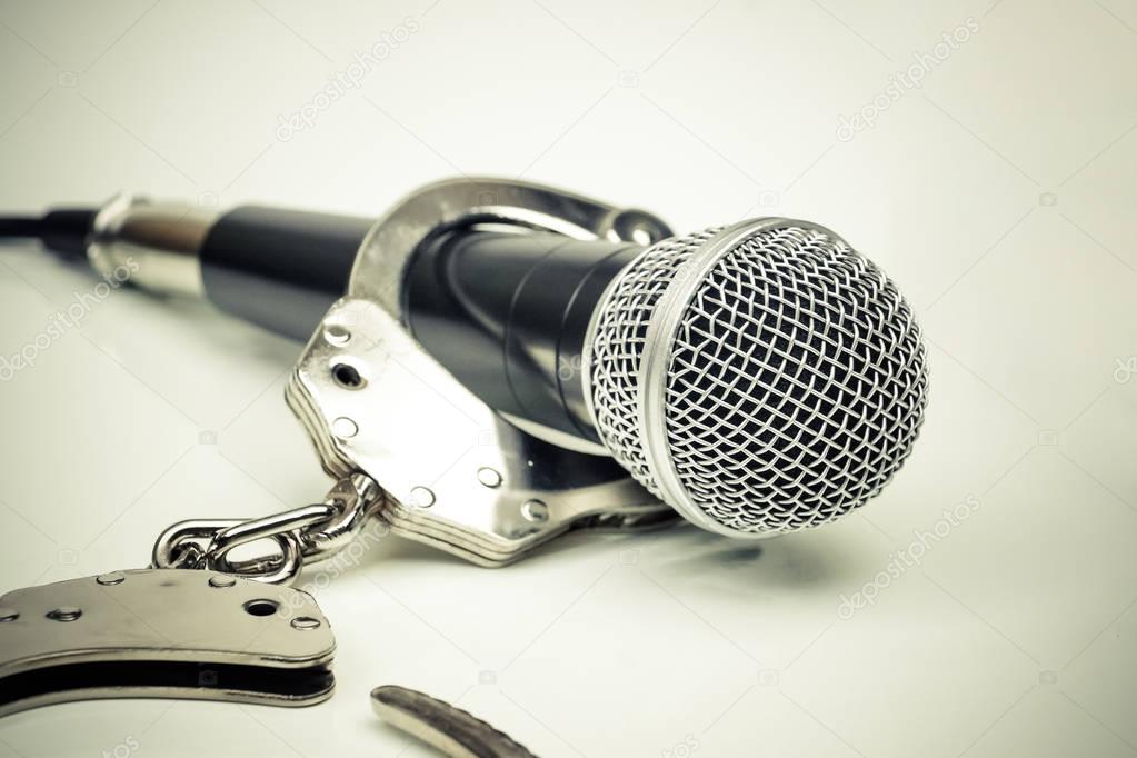 depositphotos 172517682 stock photo a microphone with handcuffs